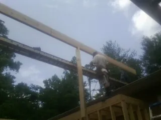 Carpenter setting a ridge beam over a new addition frame — Ice Dam Removal by Roofing Brothers in Hadlyme