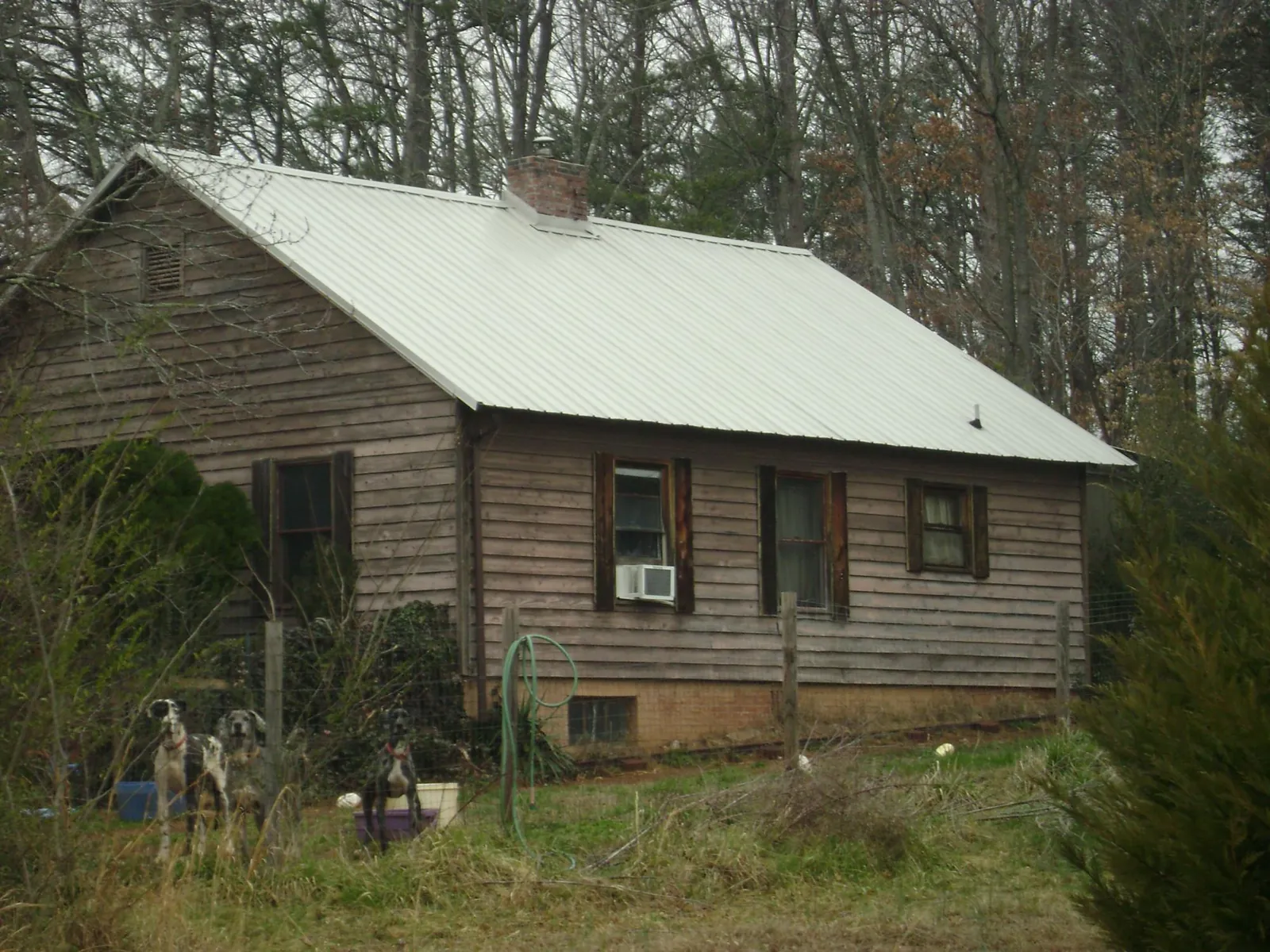 White metal roof on an old wood sided farmhouse, from a Metal Roof Installation job in Hadlyme